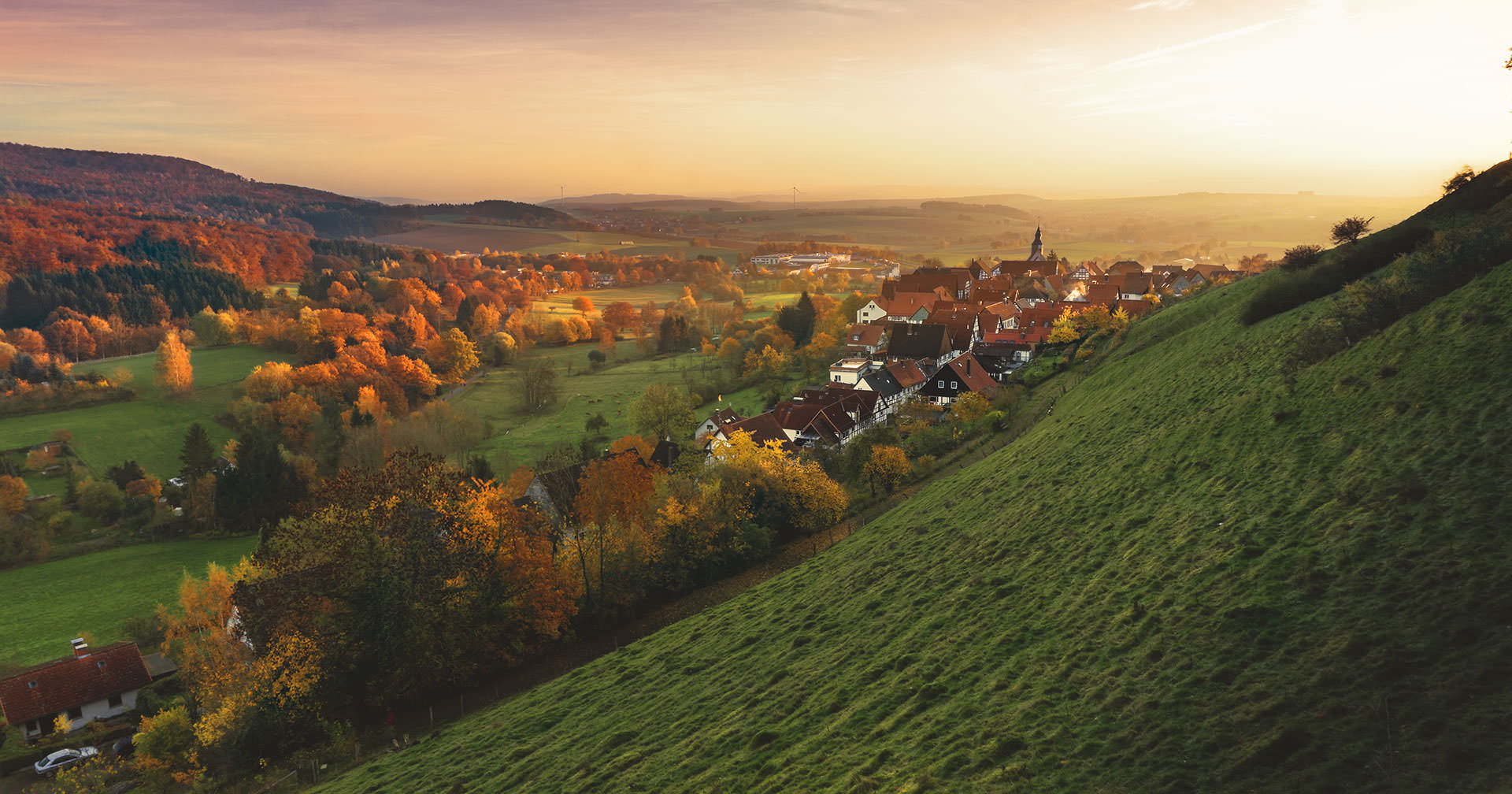 A valley landscape at sunset